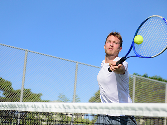 Man playing tennis.